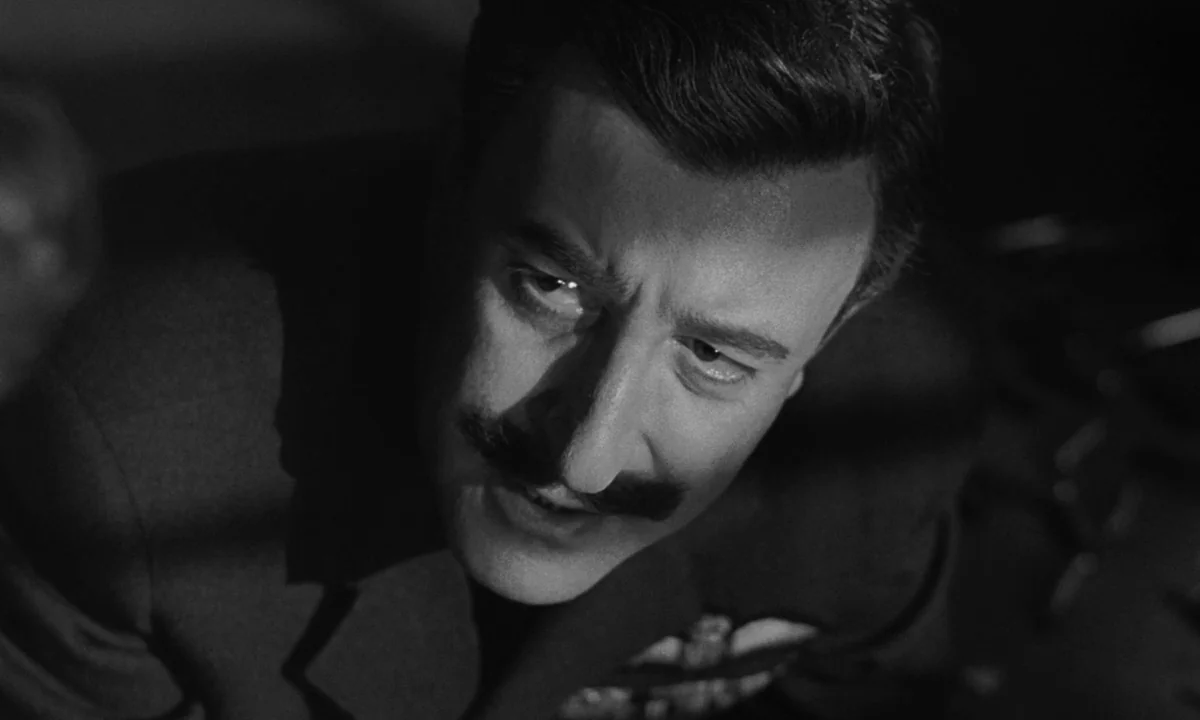 Dr. Strangelove or: How I Learned to Stop Worrying and Love the Bomb (1964) movie still: closeup — A dimly lit interior space with shadows cast…