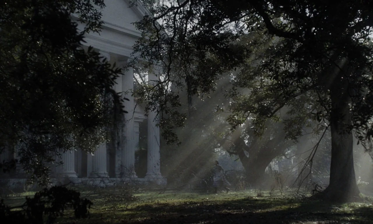 The Beguiled (2017) (2017) movie still: wide — A grand white Greek Revival house stands partially hidden behind massive, old oak trees. Sunlight…