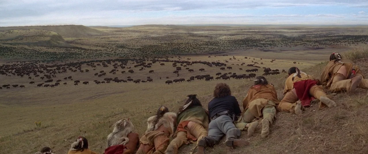 Dances With Wolves (1990) movie still: wide — A vast prairie landscape features rolling hills covered in sparse vegetation and a large herd.…