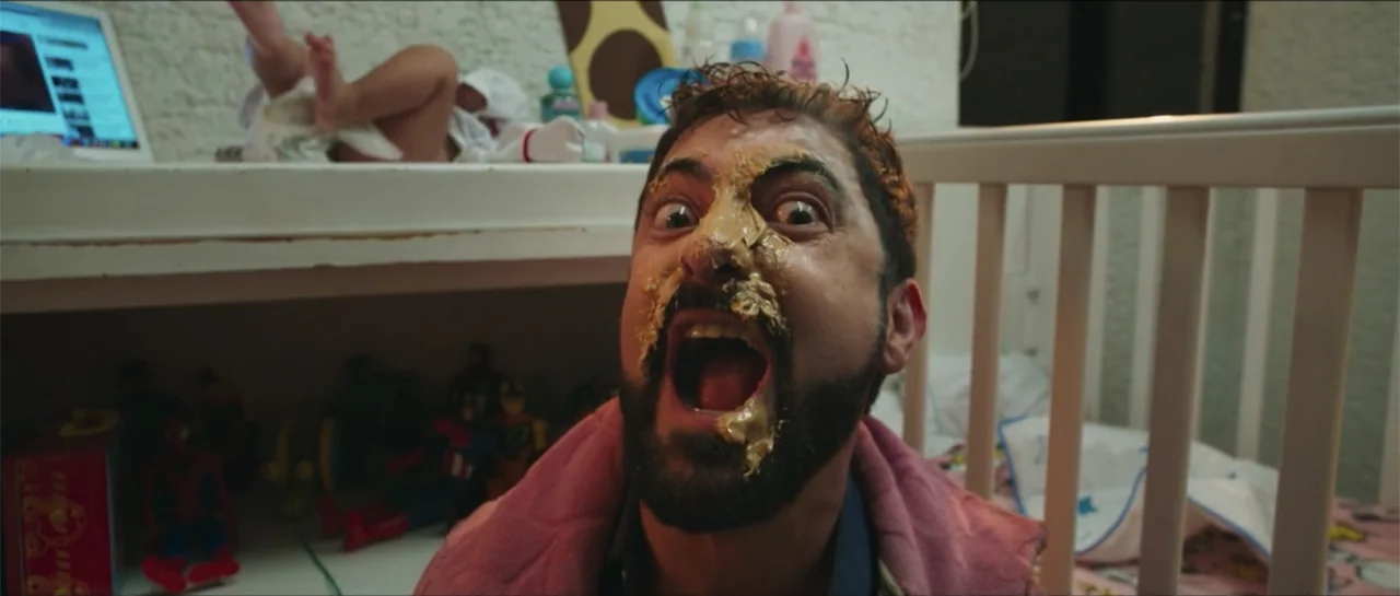 Loving is Losing (2019) movie still: closeup — A residential nursery contains a white crib and a changing table with various items. A man with…
