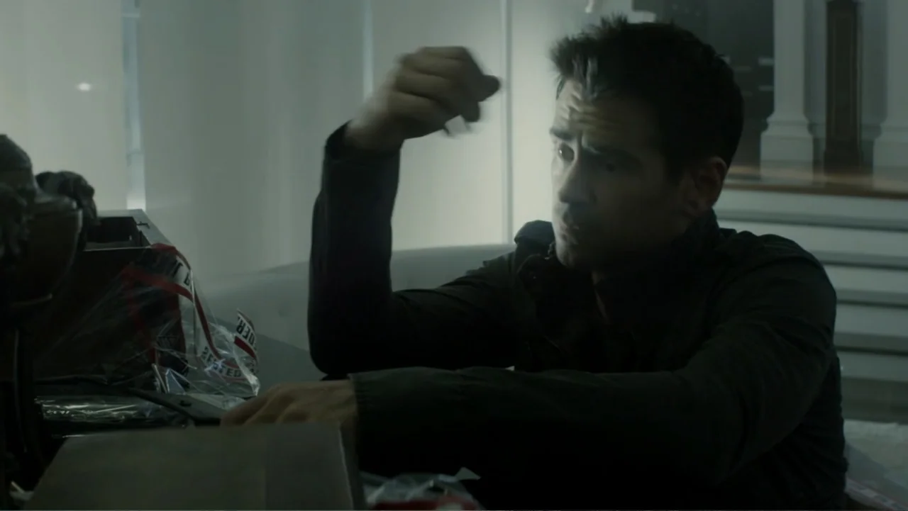 Total Recall (2012) movie still: medium — A modern office environment features bright white walls and minimalist decor elements. A man in a dark…