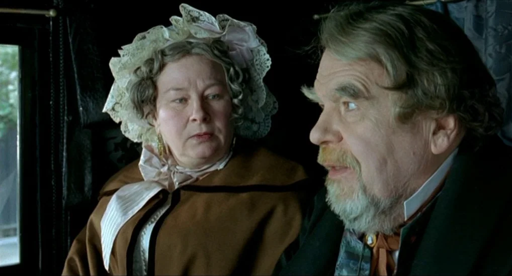 The Last Mistress (2007) movie still: medium — Interior of a period-accurate horse-drawn carriage with dark leather walls and limited space. A man…