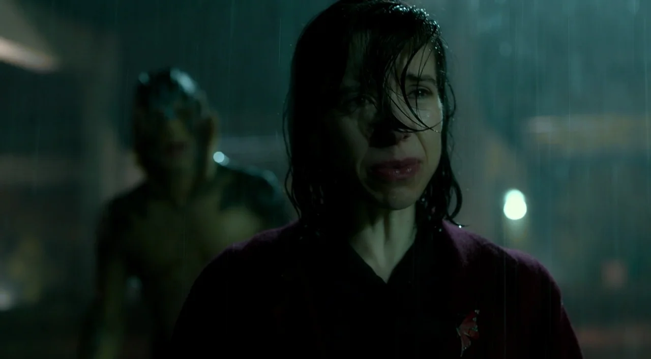 The Shape of Water (2017) movie still: medium — A dark city street is soaked in heavy rain during the late night hours. A woman with wet hair stands…
