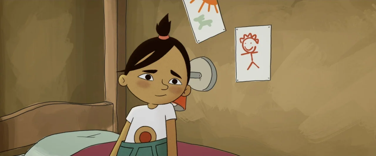 The Ape Star (2021) movie still: medium — The wall is painted a muted brown with two simple children's drawings taped up. A young girl sits on her…