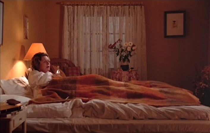 Autumn Sonata (1978) movie still: medium — A bedroom features warm-toned walls, a lacy curtained window, and a bedside lamp. A middle-aged woman…