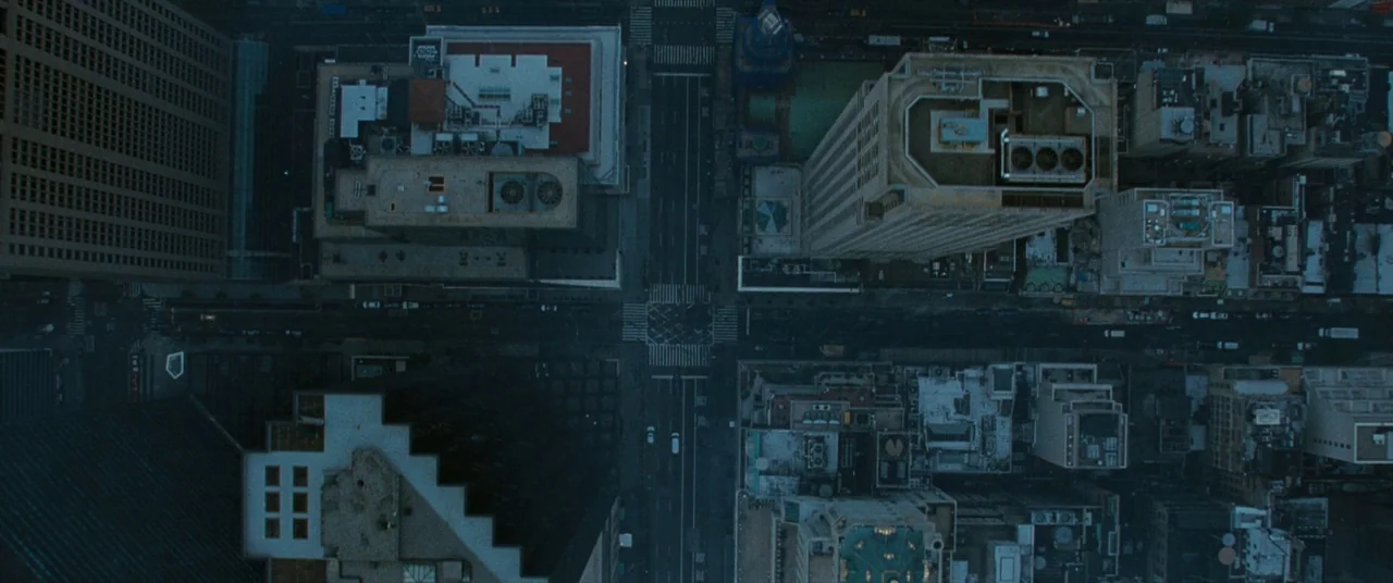 The Death and Life of John F. Donovan (2018) movie still: establishing — An overhead view shows a dense urban city block with multiple tall office…