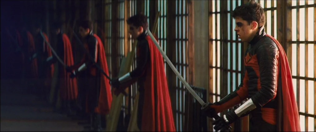 Kick Ass (2010) movie still: medium — A dark wooden room features a long row of slatted shoji windows. Multiple young trainees in matching red and…