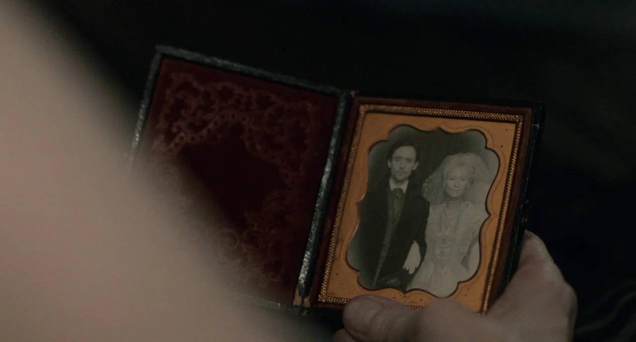 Only Lovers Left Alive (2013) movie still: closeup — A close-up shot focuses on an open, antique-style leather and brass-trimmed photograph frame.…