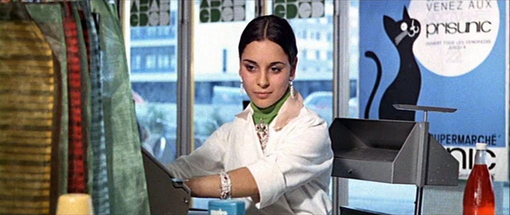 Two or Three Things I Know About Her (2 ou 3 choses que je sais d’elle) (1967) movie still: medium — A 1960s supermarket checkout counter features a…