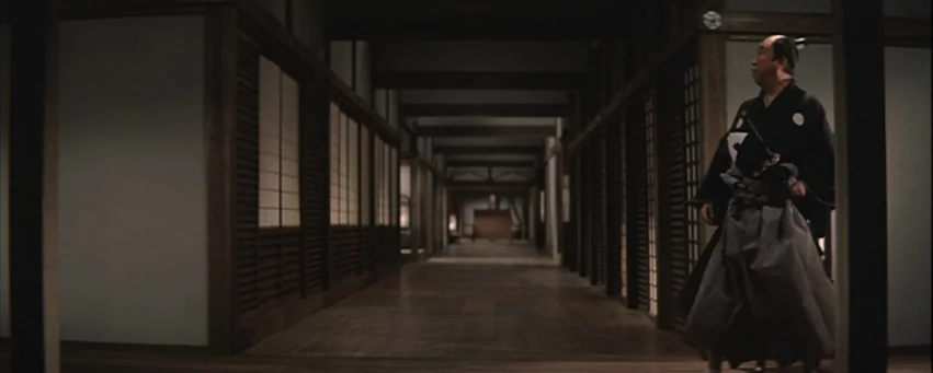 Kwaidan (1964) movie still: fullbody — A long, wooden traditional Japanese corridor features sliding shoji paper screens and wooden structural…