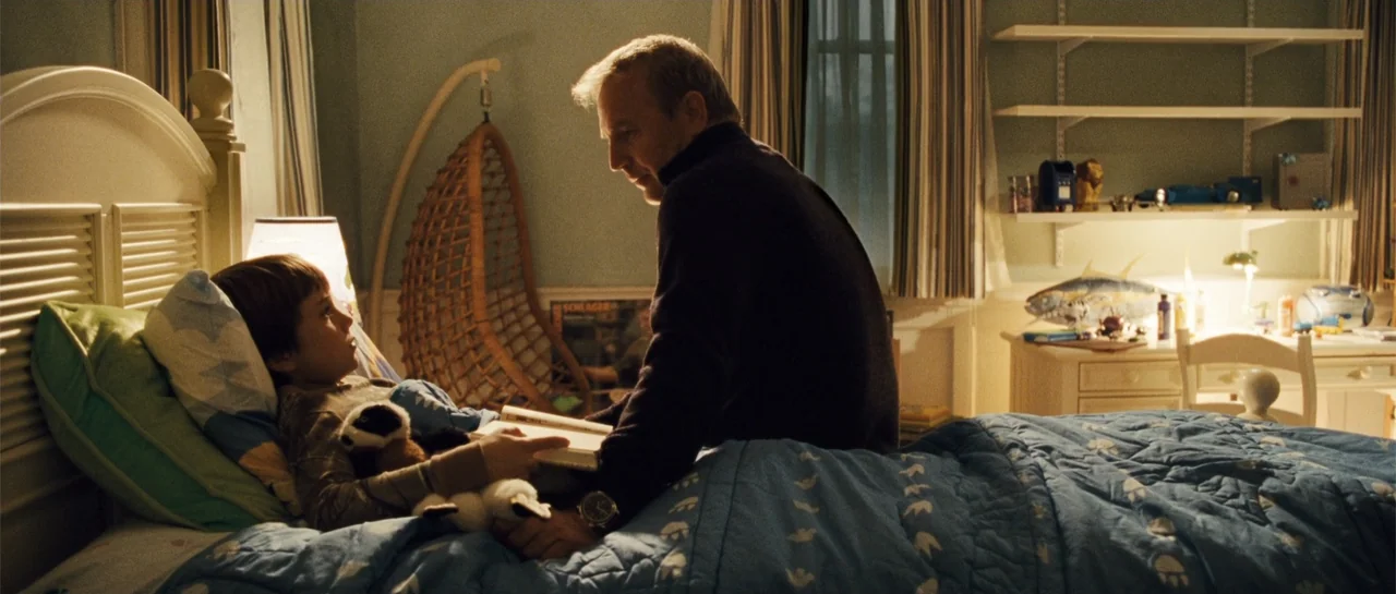 The New Daughter (2009) movie still: medium — A child's bedroom features blue bedding, a hanging wicker chair, and shelves with toys. A middle-aged…