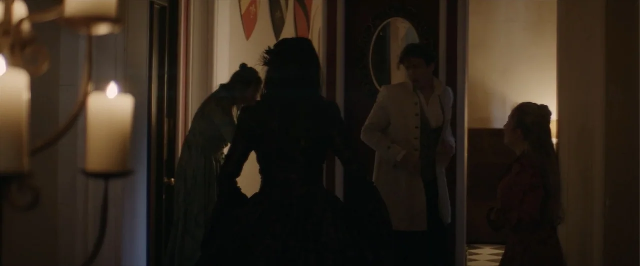 Cinderella's Curse (2024) movie still: medium — A dimly lit Victorian hallway features heraldic wall shields and a checkerboard floor visible…