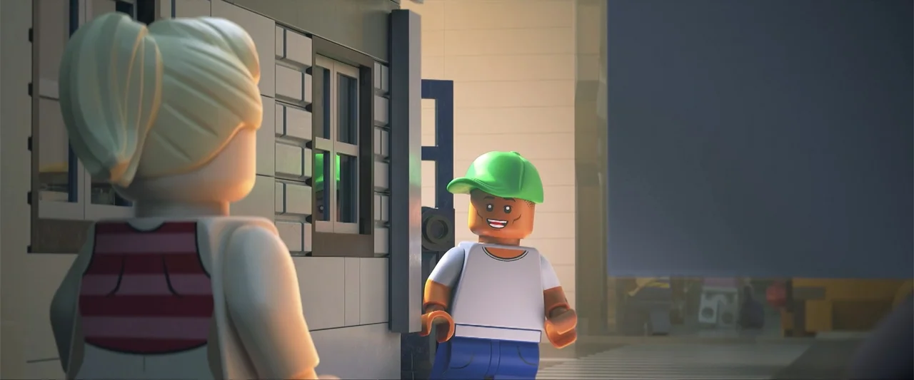 Piece by Piece (2024) movie still: medium — A suburban scene features a Lego-style man standing near a light-colored brick wall. The man is…