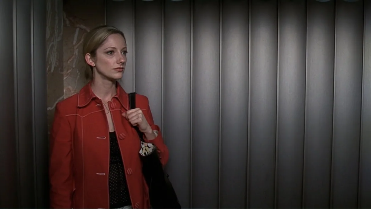 13 Going on 30 (2004) movie still: medium — An elevator interior features corrugated grey metal wall panels and a marble-patterned side wall. A…