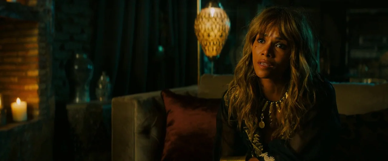 John Wick: Chapter 3 – Parabellum (2019) movie still: medium — A dark, candle-lit room with ornate lamps and deep, draped velvet curtains. A woman…