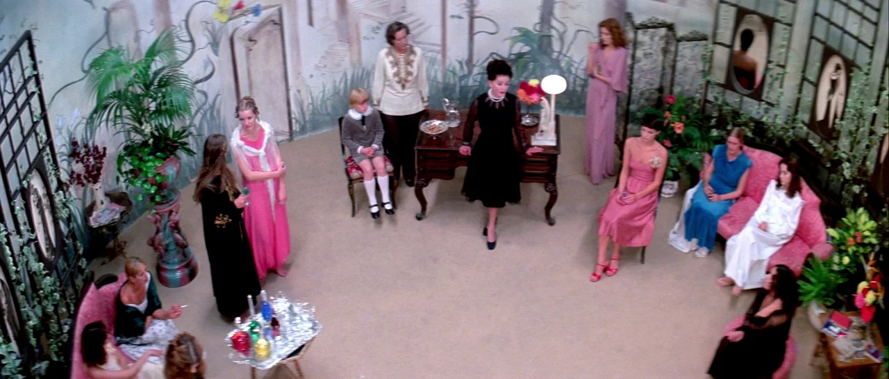 Suspiria (1977) movie still: wide — A spacious room features walls decorated with painted murals of an architectural garden landscape. Twelve women…