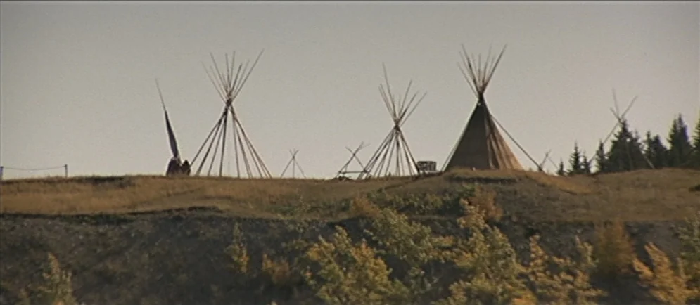Buffalo Bill and the Indians, or Sitting Bull’s History Lesson (1976) movie still: wide — A row of several tipis stands atop a grassy, dirt-covered…