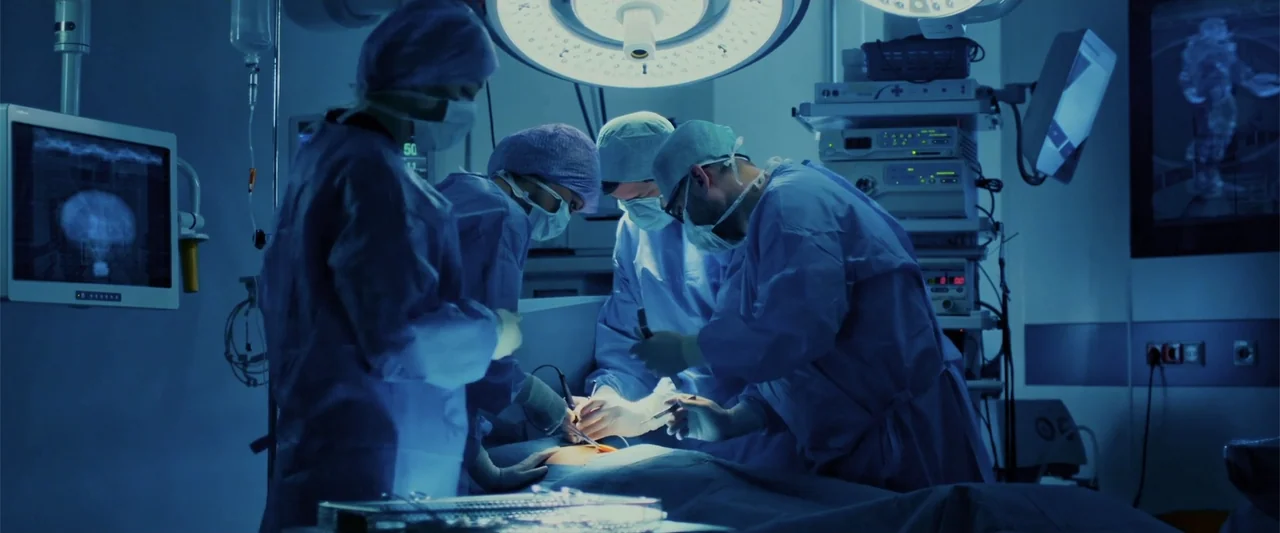 Beyond the Universe (2022) movie still: medium — A high-tech medical room filled with electronic monitoring equipment and bright surgical…