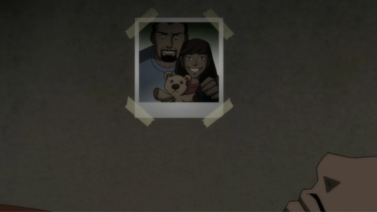 Suicide Squad: Hell to Pay (2018) movie still: medium — A framed photograph is taped to a plain grey wall with masking tape. The photo shows an…