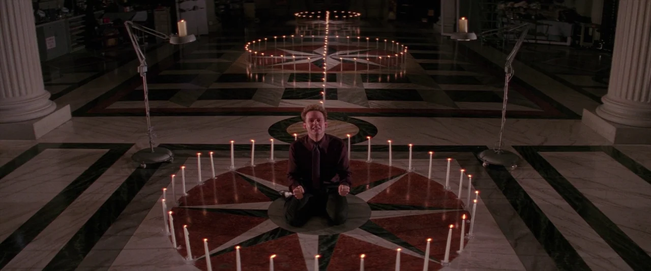 Ghostbusters 2 (1989) movie still: wide — A spacious room with a polished marble floor featuring large geometric star patterns. A man kneels in the…