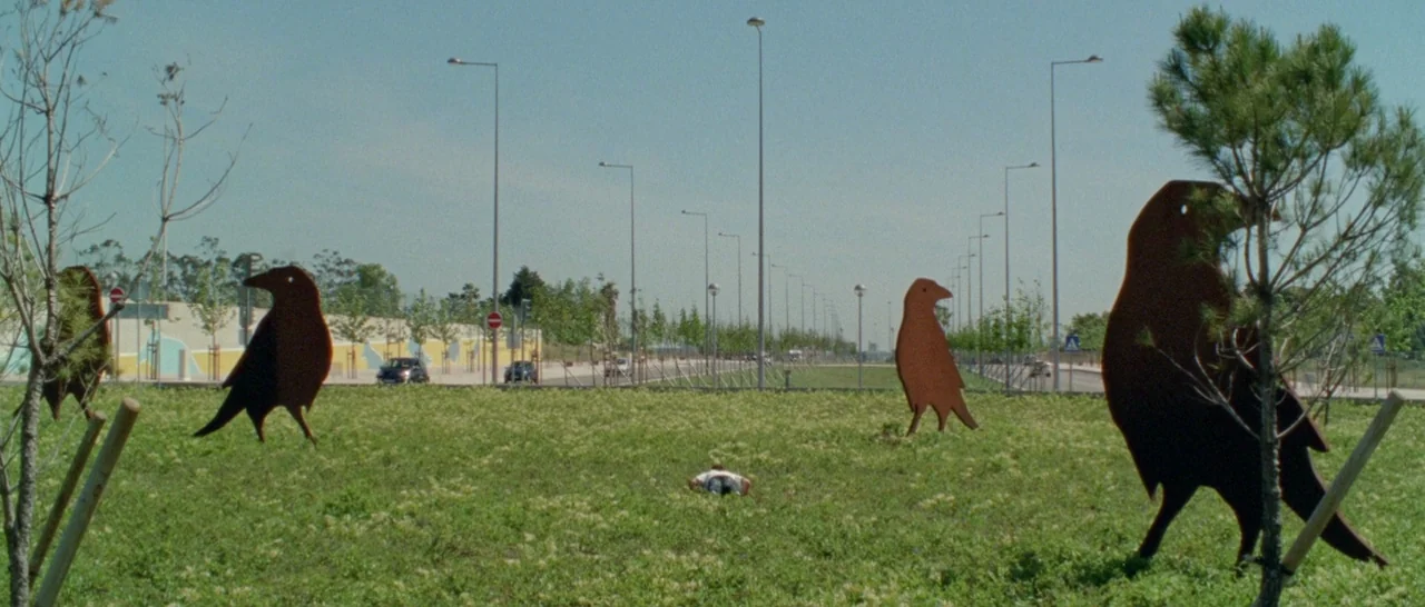 Arabian Nights: Volume 3 The Enchanted One (2015) movie still: wide — A grassy median strip features several oversized flat metal sculptures of…