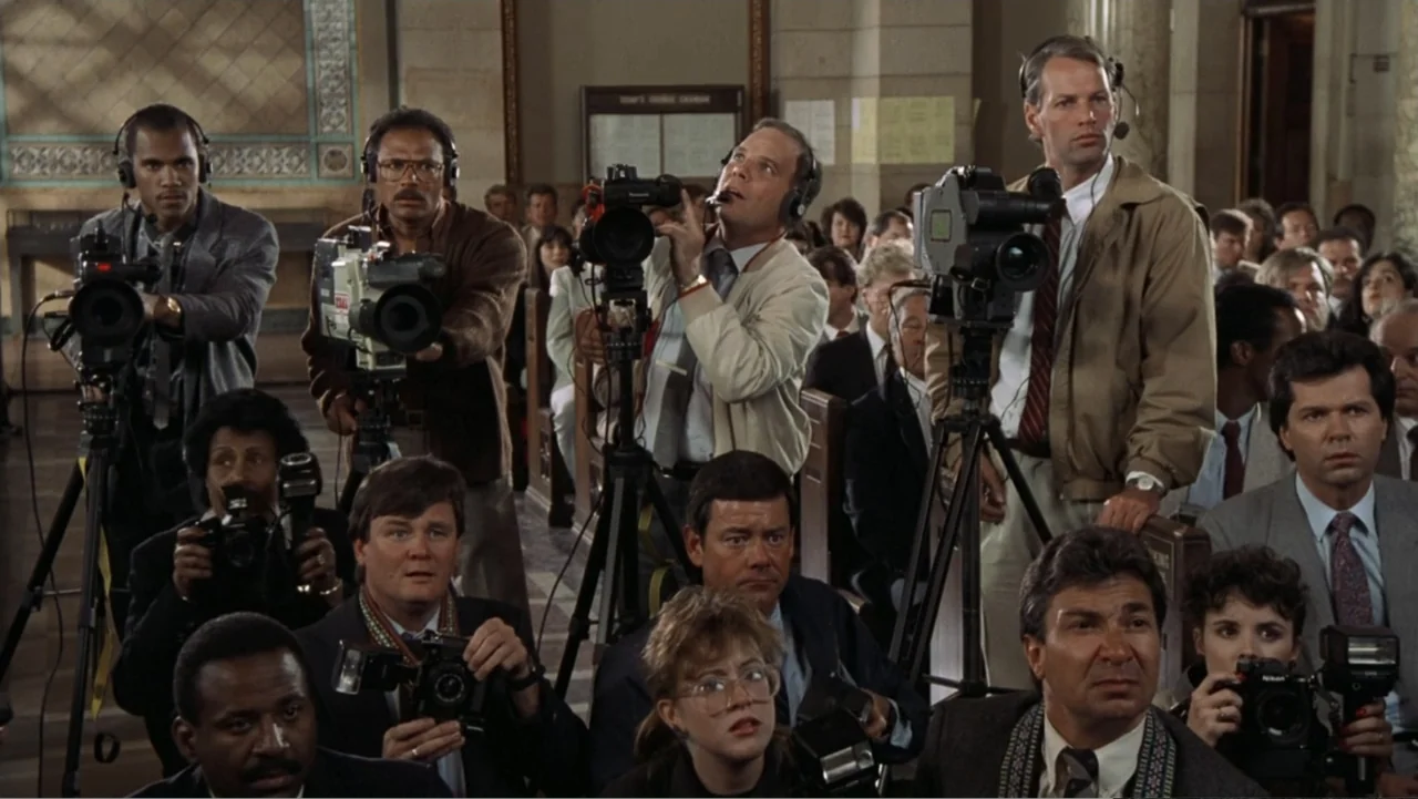The Naked Gun: From the Files of Police Squad! (1988) movie still: medium — A crowded room with people sitting on pews in a formal interior space.…