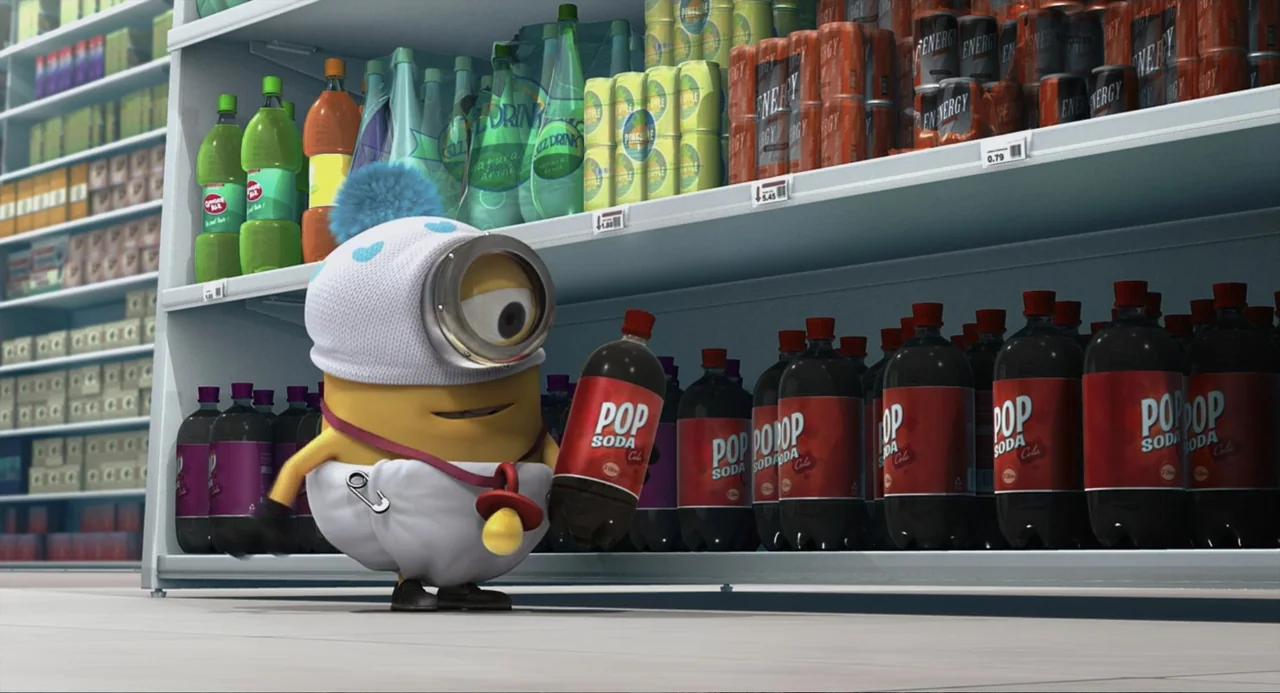Despicable Me (2010) movie still: medium — A well-stocked grocery store shelf displays various bottled sodas and canned beverages. A single yellow…