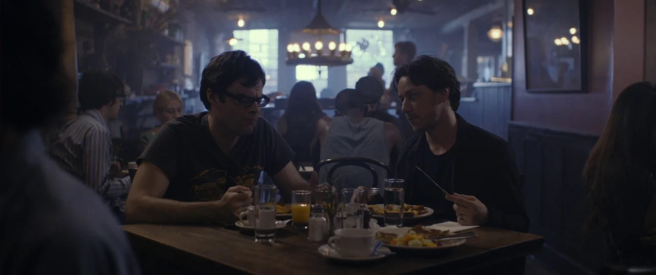 The Disappearance of Eleanor Rigby: Him (2014) movie still: medium — A dimly lit restaurant interior features dark wood tables and glowing overhead…