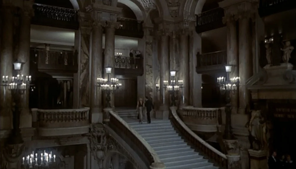 Marathon Man (1976) movie still: wide — A grand, multi-level marble interior with ornate columns and curved staircases creates a massive lobby. A…