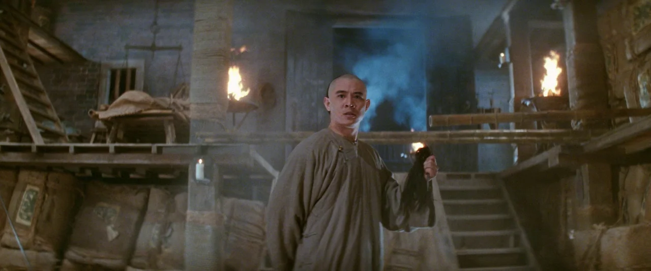 Once Upon a Time in China (1991) movie still: medium — A rustic, multi-level wooden warehouse interior is filled with stacked burlap sacks and…