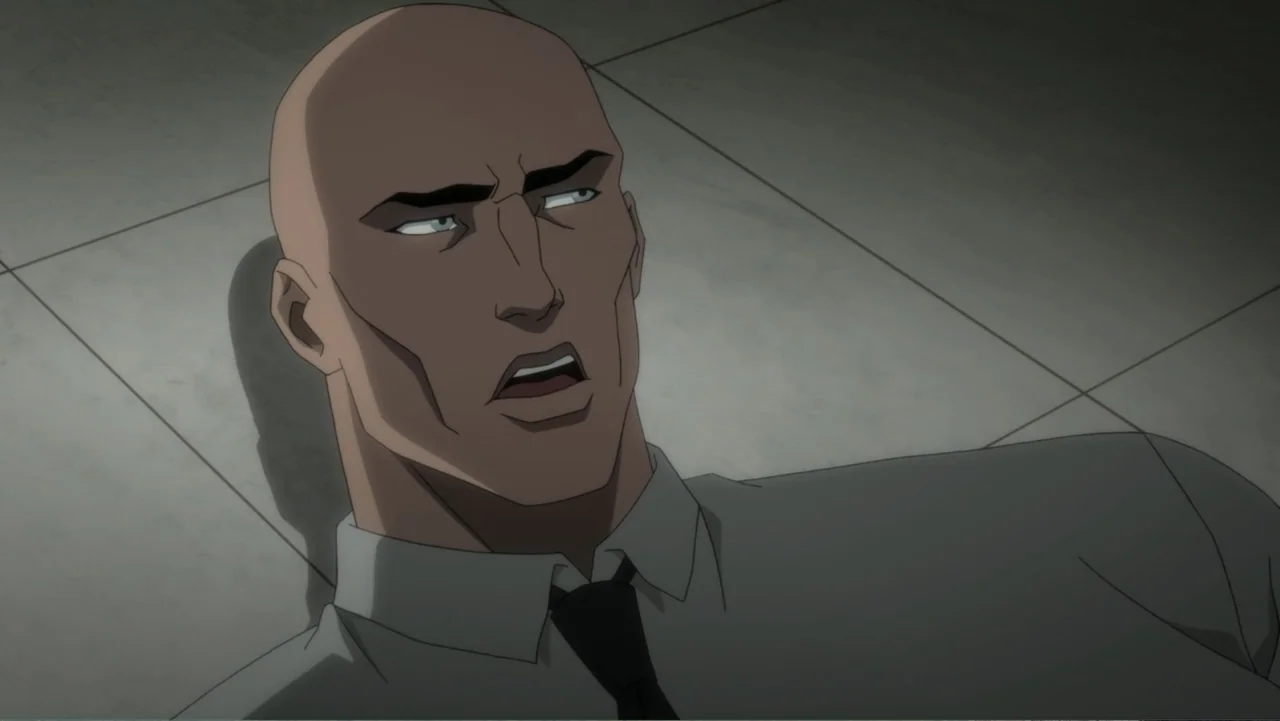 Justice League Dark: Apokolips War (2020) movie still: closeup — A bald man lies on a grey tiled floor under direct overhead lighting. The subject…