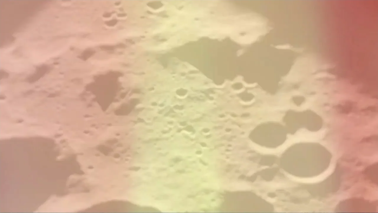 UFO Conspiracies: The Hidden Truth (2020) movie still: establishing — The rugged moon surface displays various circular impact craters and jagged…