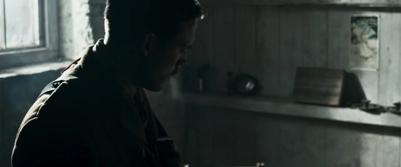 Gone Missing -  Old John's Final Journey (2014) movie still: medium — A dimly lit room with wood-paneled walls features a single high window. A…