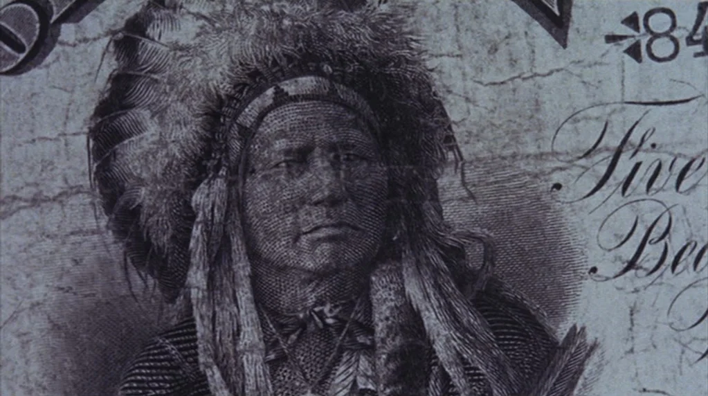The Ballad of Cable Hogue (1970) movie still: closeup — A close-up view of an engraved portrait on a historical paper banknote. The bill displays…