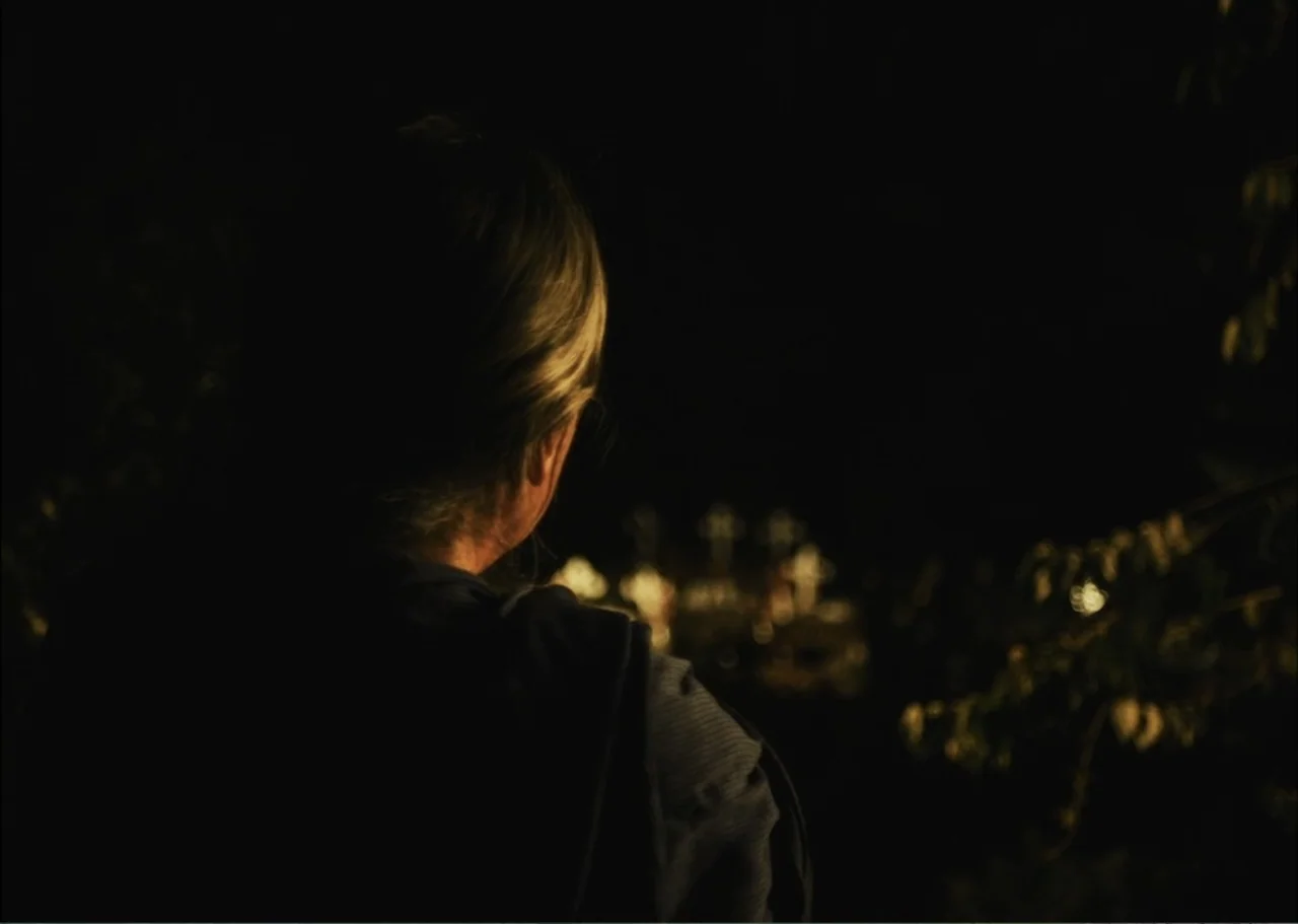 A Fisherman's Tale (1976) movie still: closeup — An outdoor night setting featuring a dark, out-of-focus background with scattered glowing crosses.…