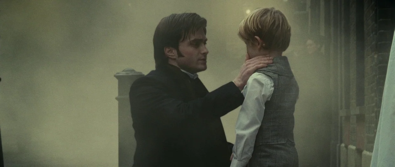 The Woman in Black (2012) movie still: medium — A dense, fog-filled Victorian-era street with brick architecture barely visible through the haze. A…