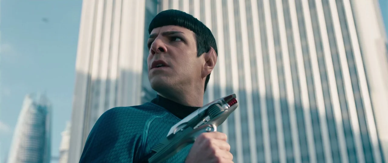 Star Trek Into Darkness (2013) movie still: medium — A man with pointed ears stands against the backdrop of large, modern glass skyscrapers. He…