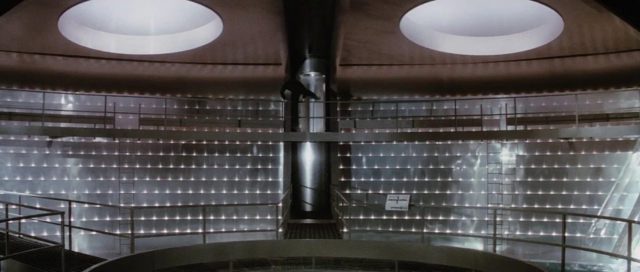 The Spy Who Loved Me (1977) movie still: wide — A high-tech circular room features a polished metal wall with integrated lights. A solitary figure…