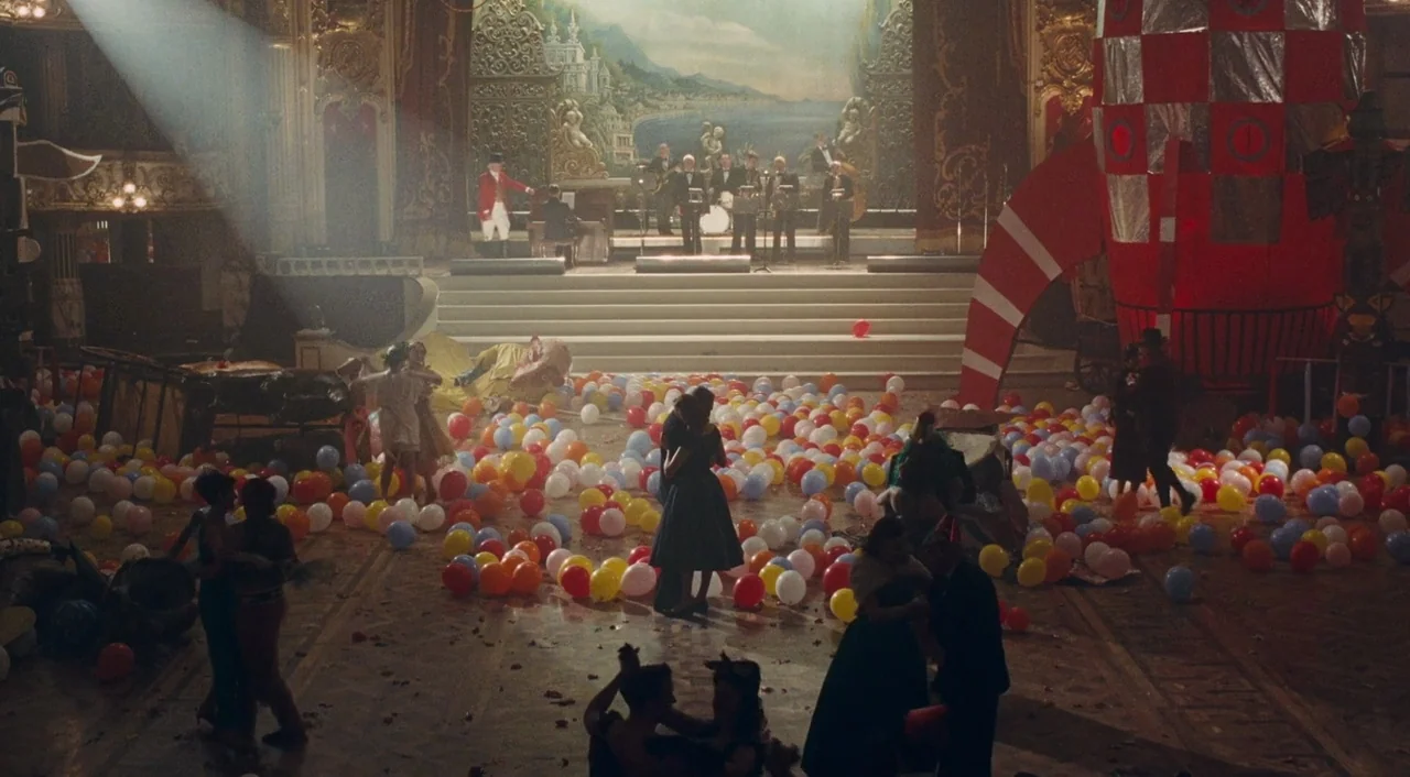 Phantom Thread (2017) movie still: wide — A grand, ornate ballroom with high ceilings features a stage for a live band. Hundreds of multi-colored…