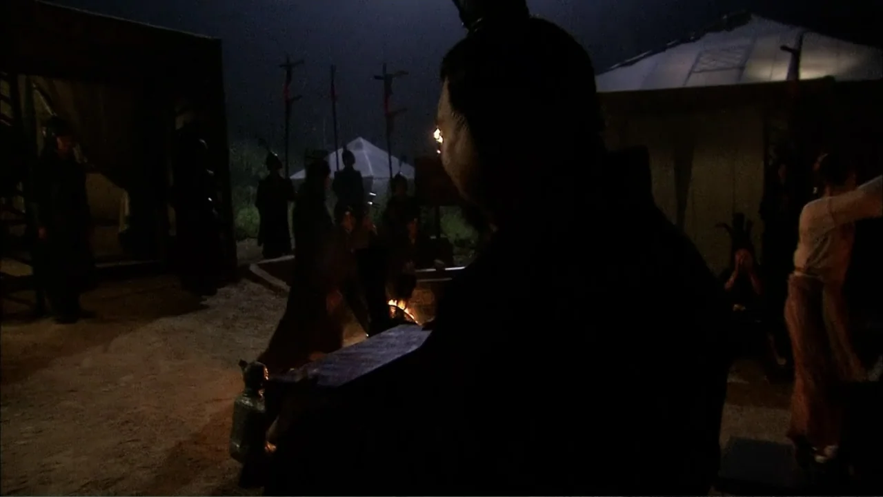 The First Emperor (2006) movie still: medium — An outdoor military encampment at night features traditional tents and people gathering around fires.…