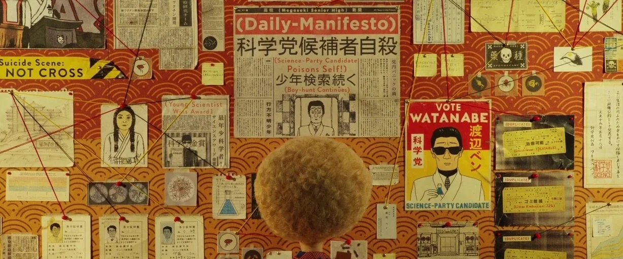 Isle of Dogs (2018) movie still: medium — A dense corkboard wall is completely covered with research papers, newspaper clippings, and string…