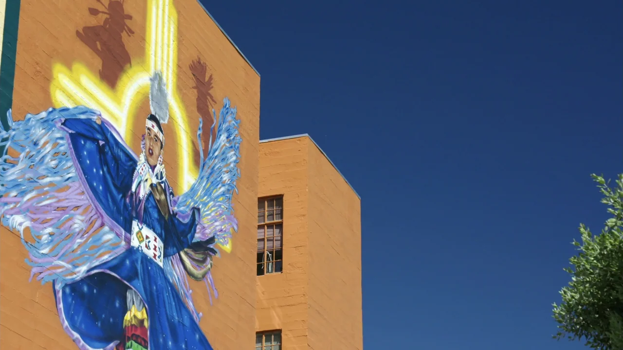We Are the Dream: The Kids of the Oakland MLK Oratorical Fest (2020) movie still: wide — An orange building exterior features a large colorful mural…