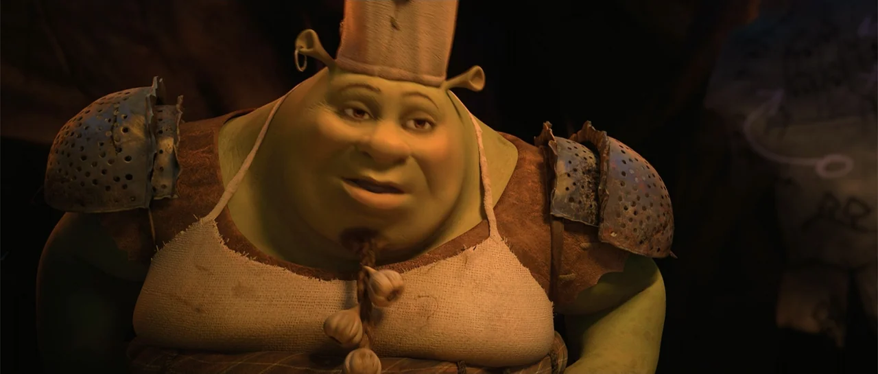 Shrek Forever After (2010) movie still: medium — A dimly lit cave interior provides a dark backdrop for an ogre chef. The ogre wearing a white apron…