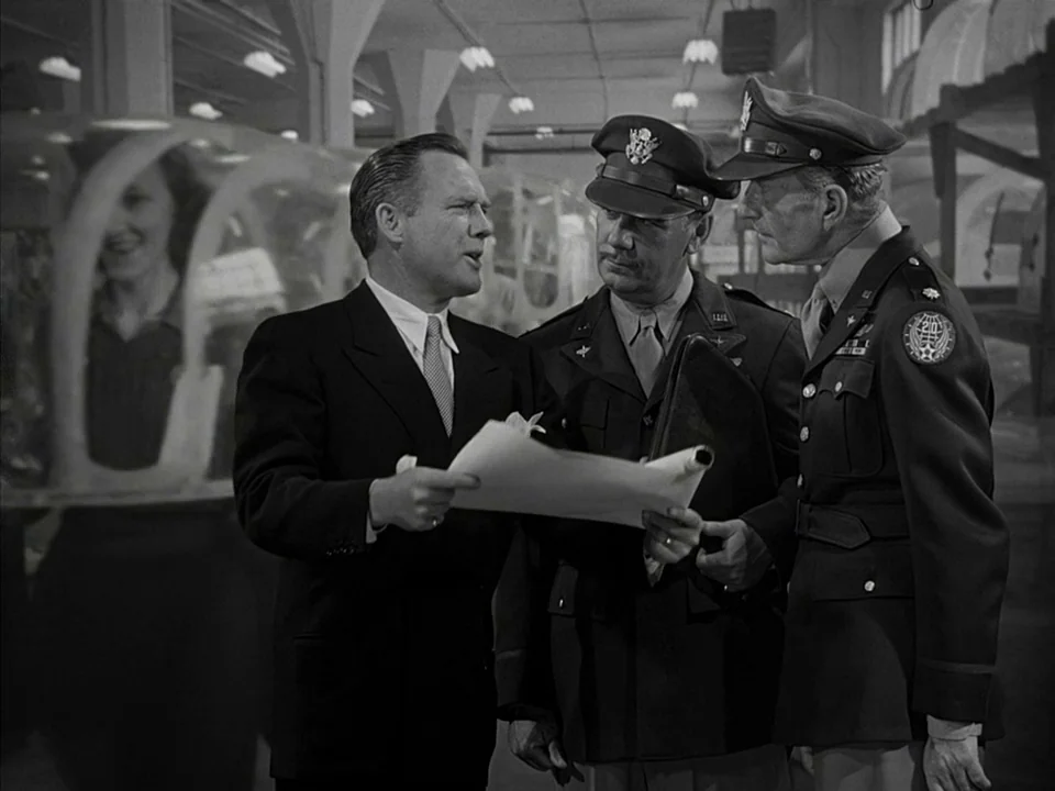 It’s A Wonderful Life (1946) movie still: medium — An industrial facility contains large translucent canopy structures behind three men standing…