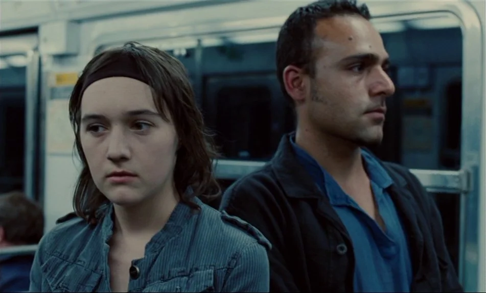 Hadewijch (2009) movie still: medium — The interior of a subway car features metal handrails and windows looking into darkness. A young woman and a…