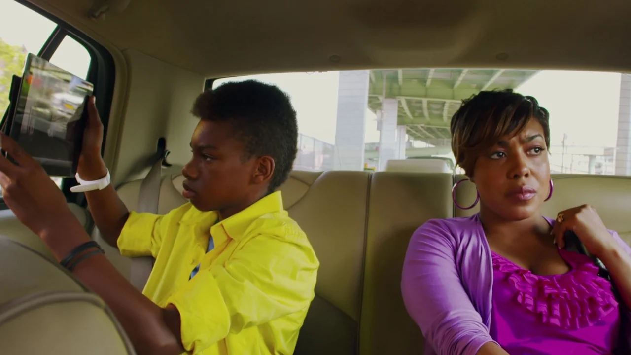 Red Hook Summer (2012) movie still: medium — The interior of a vehicle shows two passengers in the backseat looking forward. Through the back…