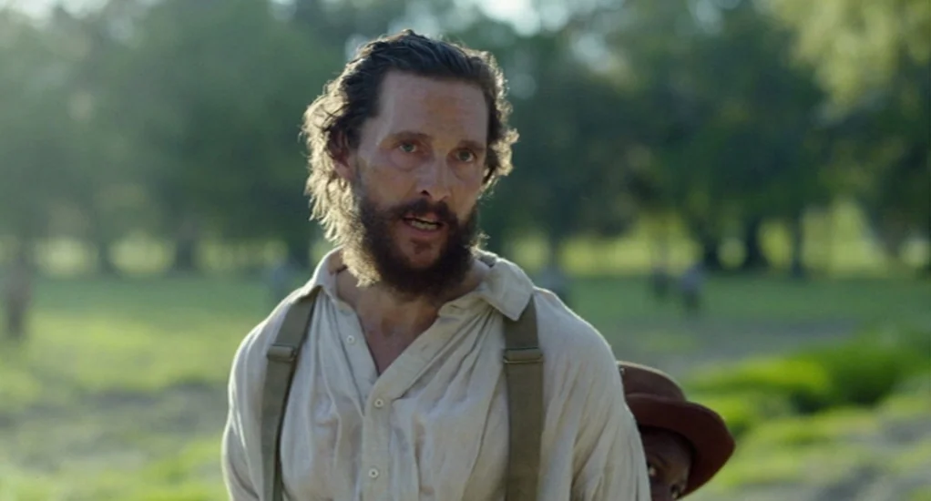 Free State of Jones (2016) movie still: medium — A man stands in an open rural field with trees visible in the background. He is speaking while…