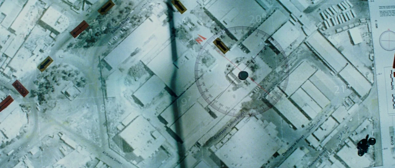 The A-Team (2010) movie still: closeup — A close-up aerial photograph of city streets marked with tactical planning overlays and directions. A…