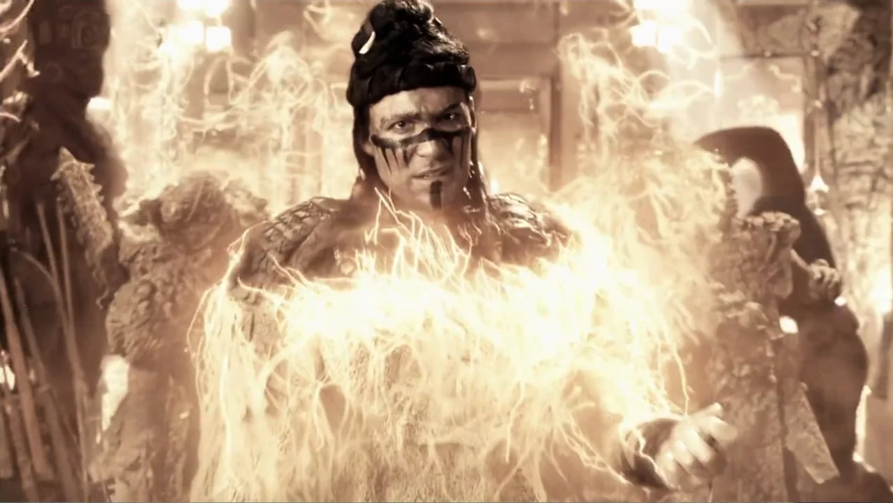 Legends of the Hidden Temple (2016) movie still: medium — An ancient stone interior is filled with swirling golden energy. A man wearing war paint…
