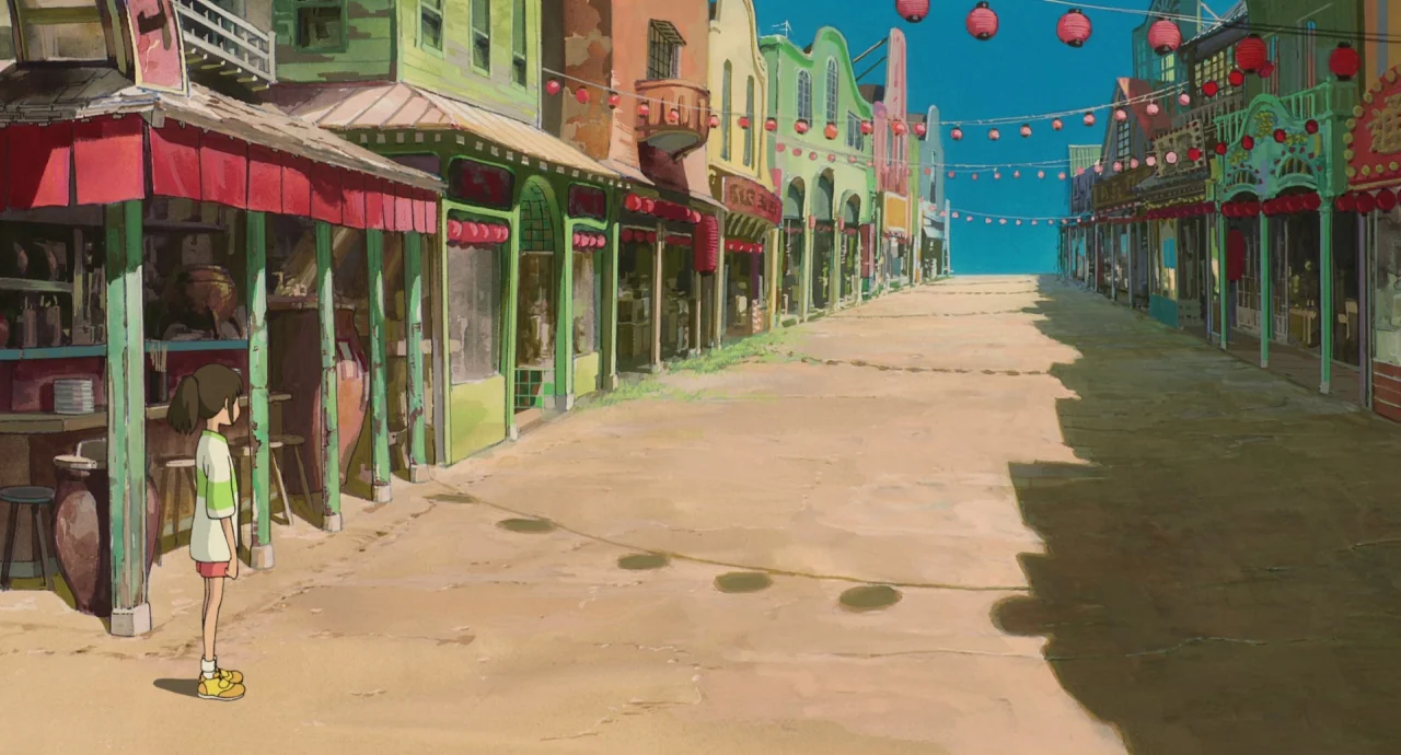 Spirited Away (2001) movie still: fullbody — A quiet, deserted street lined with colorful, weathered buildings under a clear blue sky. A young girl…
